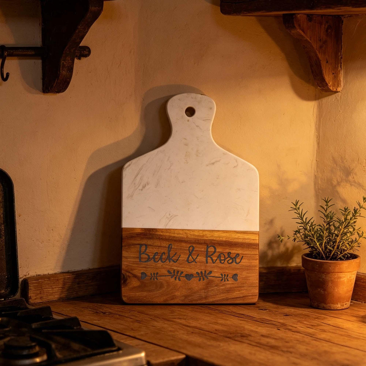 Personalised Marble & Acacia Serving Board with Handle: marble and acacia serving board engraved with names, in warm light