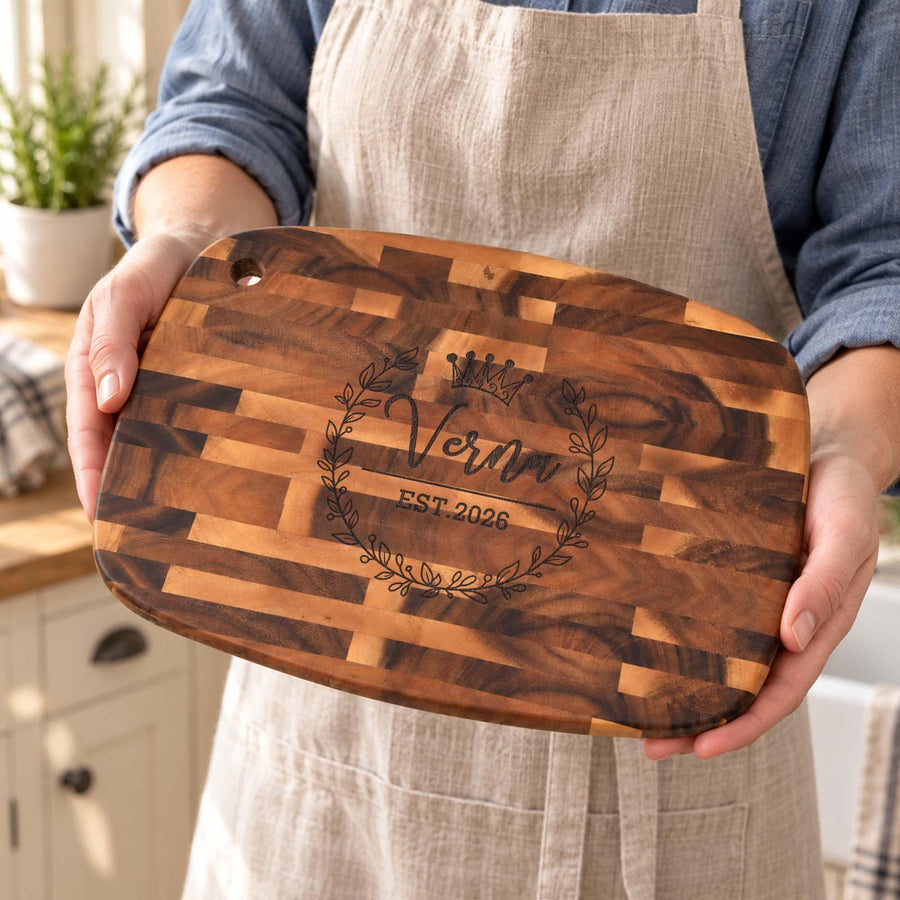 Personalised Reversible End-Grain Acacia Board: personalised reversible end-grain acacia board held in front of an apron