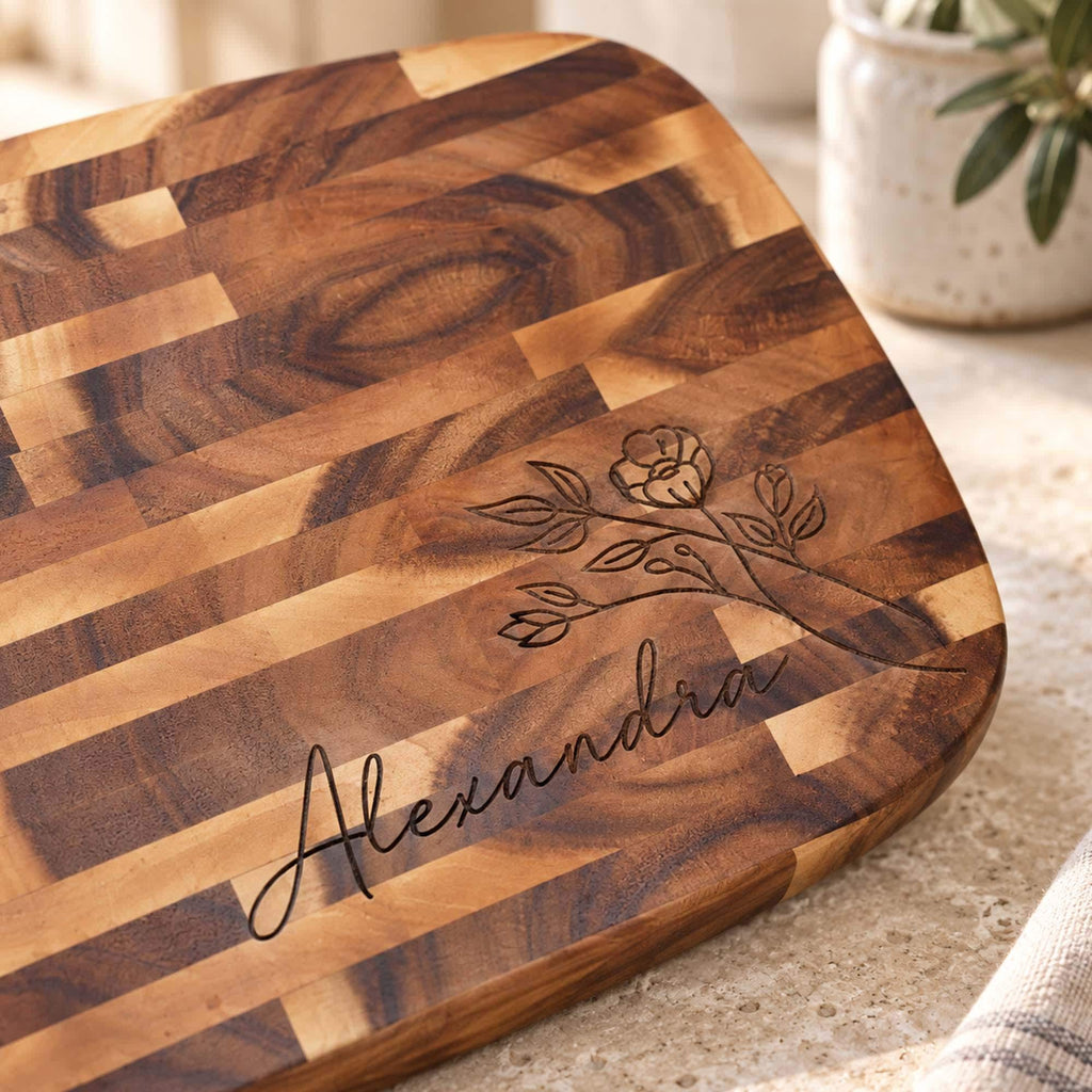 Personalised Reversible End-Grain Acacia Board: close-up of a floral design and name engraved on end-grain acacia
